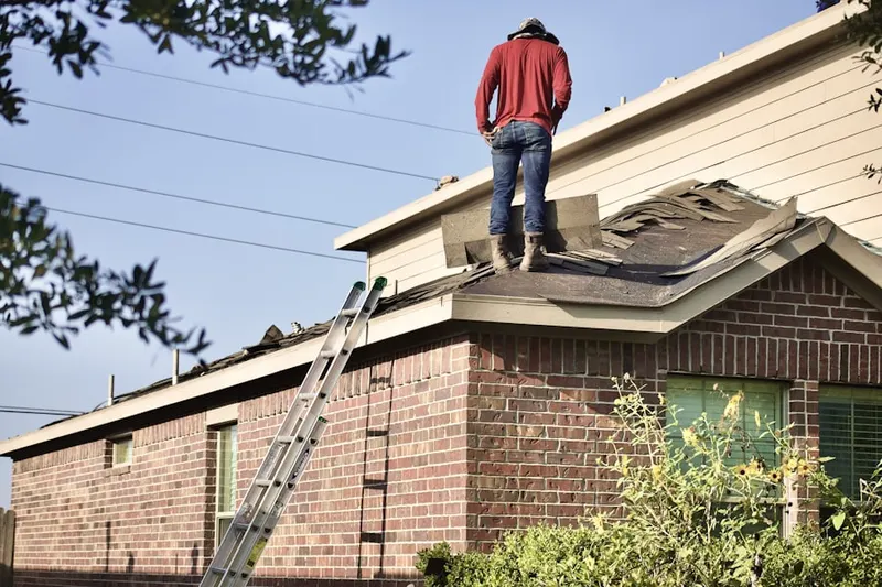 Professional roofer working on a residential roof in Carroll Manor Ridge